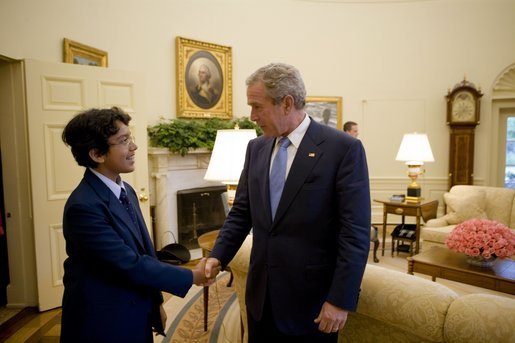 President George W. Bush welcomes 13-year-old Anurag Kashyap of Poway, Calif., the 2005 E. W. Scripps National Spelling Bee Champion, to the Oval Office Monday, July 18, 2005. White House photo by Eric Draper