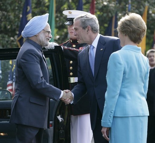 President George W. Bush and Laura Bush welcome India's Prime Minister Dr. Manmohan Singh upon his arrival to the White House, Monday, July 18, 2005. White House photo by Eric Draper