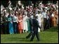 President George W. Bush and India's Prime Minister Dr. Manmohan Singh are cheered by invited guests, Monday, July 18, 2005 on the South Lawn of the White House, during the official arrival ceremony for Prime Minister Singh. White House photo by Lynden Steele