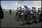 Soldiers parade by President George W. Bush and Laura Bush during an arrival ceremony at Glasgow Prestwick International Airport in Scotland July 6, 2005. White House photo by Krisanne Johnson