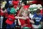 A young ballplayer from the West University Little League Challengers from Houston, Texas, cheers with her team Sunday, July 24, 2005, at a Tee Ball game on the South Lawn of the White House. White House photo by Carolyn Drake