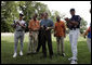 President George W. Bush laughs with Major League Baseball Hall of Fame players Ozzie Smith and Paul Molitor and former umpire Steve Palermo while congratulating Challenger Tee Ball players after a game on the South Lawn of the White House on Sunday July 24, 2005. White House photo by Paul Morse