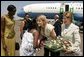 Laura Bush and daughter Jenna Bush are greeted at an arrival ceremony Thursday, July 14, 2005 at Kigali International Airport in Kigali, Rwanda. White House photo by Krisanne Johnson