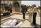 Laura Bush and daughter Jenna lay a wreath Thursday, July 14, 2005 at the Kigali Memorial Center-Gisozi Genocide Memorial in Kigali, Rwanda. White House photo by Krisanne Johnson