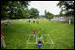 A member of the McGuire AFB Little League Yankees makes a hit on the South Lawn of the White House during action in the opening game of the 2006 Tee Ball season, Friday, June 23, 2006, between the McGuire AFB Yankees and the Dolcom Little League Indians of the Naval Submarine Base from Groton, Ct. White House photo by Paul Morse