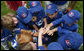 Teammates of the Dolcom Little League Indians of the Naval Submarine Base of Groton, Ct., huddle together for a cheer during the opening Tee Ball game of the 2006 season on the South Lawn of the White House, Friday, June 23, 2006, between the Dolcom Indians and the McGuire AFB Little league Yankees. White House photo by Paul Morse