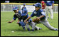 Three players for the Dolcom Little League Indians of the Naval Submarine Base in Groton, Ct., all dive for the ball on the South Lawn of the White House during action in the opening game of the 2006 Tee Ball season, Friday, June 23, 2006, between the McGuire Air Force Base Little League Yankees and the Dolcom Little League Indians. White House photo by Paul Morse