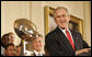 President George W. Bush stands next to the Super Bowl Trophy as he welcomes the Super Bowl Champion Pittsburgh Steelers to the White House, Friday, June 2, 2006, during a ceremony in the East Room to honor the Super Bowl champs. White House photo by Eric Draper