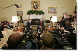 President George W. Bush and Colombian President Alvaro Uribe meet with the press in the Oval Office Wednesday, June 14, 2006. "We talked about trade. We negotiated a free trade agreement," said President Bush. "We've still got some details to work out, but we committed ourselves to working out those details and try to get this done as quickly as we can." White House photo by Paul Morse