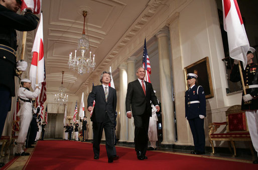 President George W. Bush and Japan’s Prime Minister Junichiro Koizumi walk through Cross Hall on their way to a joint press availability Thursday, June 29, 2006, in the East Room of the White House. White House photo by Paul Morse