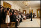 President George W. Bush takes a question from one of the 2006 Presidential Scholars in the East Room Monday, June 26, 2006. The program was established in 1964, and recognizes up to 141 distinguished graduating high school seniors. White House photo by Paul Morse