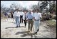 Vice President Dick Cheney walks with a resident of a Gulfport, Mississippi neighborhood Thursday, September 8, 2005. The area was damaged by Hurricane Katrina, which hit both Louisiana and Mississippi on August 29th. Mrs. Cheney and Mayor Brent Warr are also shown walking. White House photo by David Bohrer