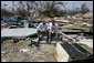 President George W. Bush spends a moment with a Patrick Wright during his walking tour Friday, Sept. 2, 2005, of Biloxi, Miss. "You know, there's a lot of sadness, of course," said the President of the devastated area. "But there's also a spirit here in Mississippi that is uplifting." White House photo by Eric Draper