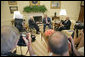 President George W. Bush accepts a report from former President Jimmy Carter and Secretary of State James Baker, Co-Chairs of the Carter-Baker Commission on Federal Election Reform, in the Oval Office Monday, Sept. 19, 2005. White House photo by Eric Draper