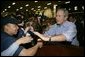 President George W. Bush greets sailors aboard the USS Iwo Jima after delivering remarks on hurricane recovery efforts during an Address to the Nation in New Orleans, La., Thursday, Sept. 15, 2005. White House photo by Eric Draper