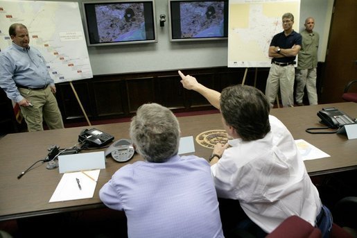 President George W. Bush and Texas Governor Rick Perry, right, participate in a meeting with Texas officials inside the Texas Emergency Operations Center in Austin, Texas, Saturday, Sept. 24, 2005. White House photo by Eric Draper