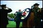 President George W. Bush places a flower on a memorial wreath during the Annual Peace Officers' Memorial Service at the U.S. Capitol Washington, D.C., Thursday, May 15, 2003. White House photo by Paul Morse.