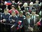 World War II Filipino-American veterans cheer for Presidents Bush and Arroyo. "I am proud of the contributions that Filipinos and Filipino Americans make to the American economy and society," said President Arroyo in her remarks. "In a quiet, but equally substantive way, we can compare it to the contribution made by Philippine World War II veterans to the defense of our common freedom and security." White House photo by Tina Hager