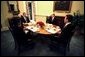 President George W. Bush has breakfast with Danish Prime Minister Anders Fogh Rasmussen, far right, National Security Advisor Condoleezza Rice, left, and Denmark’s ambassador to the U.S. Ulrik Federspiel, in the private dining room of the White House Thursday, May 8, 2003. White House photo by Eric Draper