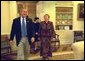 President George W. Bush laughs with Ludmila Putina, wife of Russian Federation President Vladimir Putin, during an impromptu tour of the Oval Office Saturday, October 12, 2002. Mrs. Putina then joined Laura Bush on a visit to the Second Annual National Book Festival on the west side of the Capitol. More than 70 authors, story tellers and athletes read from their works, signed books and encouraged reading for all ages. White House photo by Susan Sterner.