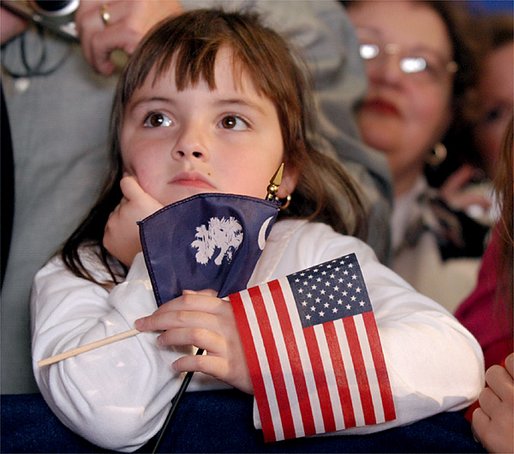 Holding the colors of South Carolina and America, a young girl listens to President George W. Bush during the South Carolina Welcome in Columbia, S.C., Thursday, Oct. 24. White House photo by Eric Draper.