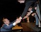 President George W. Bush greets stage participants after speaking at the North Carolina Welcome in Charlotte, N.C., Thursday, Oct. 24. White House photo by Eric Draper.