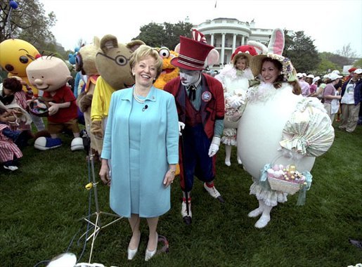 Accompanied by all sorts of story book characters, Lynne Cheney the host of the 2003 White House Easter Egg Roll, addresses the media on the South Lawn Monday, April 21, 2003. "But most of all, we are proud of all of you, the men and women who serve our country, who keep our country free," said Mrs. Cheney in her opening remarks welcoming U.S. military families to the event. White House photo by David Bohrer