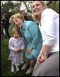 Visiting one-on-one with many families and children, Lynne Cheney poses for pictures on the South Lawn at the White House Easter Egg Roll Monday, April 21, 2003. White House photo by David Bohrer
