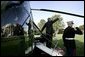 President George W. Bush waves from the steps of Marine One before departing the South Lawn Monday morning, Oct. 4, 2004. The President left for Des Moines, Iowa, to sign H.R. 1308, the Working Families Tax Relief Act of 2004. White House photo by Eric Draper