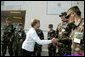 Laura Bush is greeted by members of the National Guard outside the Emergency Operations Center in Vero Beach, Fla., Friday, Oct. 1, 2004. White House photo by Joyce Naltchayan.