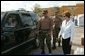 Laura Bush greets a local resident with members of the National Guard at the Indian River County Distribution Center where water, ice and Meals Ready To Eat (MRE) are passed out to residents recovering from Hurricanes Jeanne and Frances in Vero Beach, Fla., Friday, October 1, 2004. White House photo by Joyce Naltchayan.