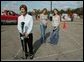 Laura Bush speaks to reporters after working with volunteers at the Indian River County Distribution Center as her daughters, Jenna and Barbara stand with her in Vero Beach, Fla., Friday, October 1, 2004. White House photo by Joyce Naltchayan.