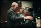 President George W. Bush talks with World War II Veterans Jose Ramos Chavez, left, and his younger brother Joe Diego Chavez, both of Albuquerque, N.M., during a breakfast with Secretary of Veterans Affairs Anthony Principi, Senator Bob Dole and World War II Veterans in the Executive Dining Room at the White House Friday, May 28, 2004. The brothers served in the Army during WWII. Jose took part in the D-Day invasion at Normandy, France, and Joe served in both the Atlantic and Pacific theaters. File photo. White House photo by Eric Draper.