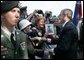 President George W. Bush meets with veterans and their families after delivering remarks during ceremonies marking the 60th anniversary of D-Day at the American Cemetery in Normandy, France, June 6, 2004. File Photo. White House photo by Eric Draper.