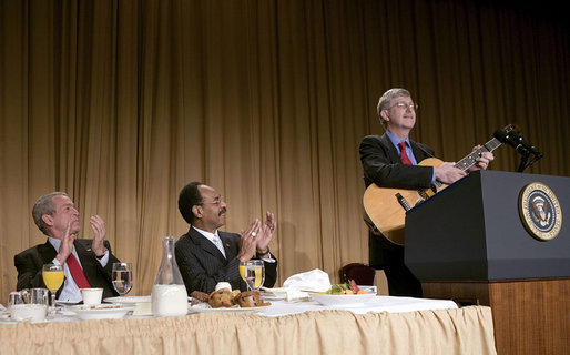 President George W. Bush and Representative Emanuel Cleaver, D-Mo., listen to Dr. Francis Collins during the National Prayer Breakfast in Washington, D.C., Thursday, Feb. 1, 2007. Dr. Collins is the director of the National Human Genome Research Institute. White House photo by Eric Draper