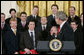 President George W. Bush jokes with members of the Carolina Hurricanes hockey team, winners of the 2006 Stanley Cup, Friday, Feb. 2, 2007 in the East Room at the White House. White House photo by Paul Morse