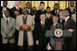 President George W. Bush draws a laugh from the Miami Heat as the 2006 NBA champs visited the White House Tuesday, Feb. 27, 2007. "This is a championship team on the court, and this is a championship team off the court," said the President. "And it is my high honor to welcome them to the White House as NBA champs." White House photo by Eric Draper
