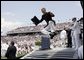 A U.S. Naval Academy graduate celebrates after receiving his diploma in Annapolis, Md., Friday, May 27, 2005. White House photo by Paul Morse