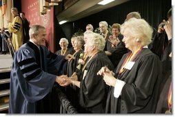 President George W. Bush greets members of the 50th anniversary class of Calvin College after giving a commencement address at Calvin College in Grand Rapids, Michigan on Saturday May 21. White House photo by Paul Morse