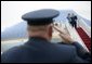 President George W. Bush returns a salute from Brigadier General David S. Gray, Commander, 89th Airlift Wing as he and Mrs Bush board Air Force One before departing Andrews Air Force Base for Latvia, Friday, May 6, 2005. White House photo by Eric Draper