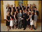 President George W. Bush stands with members of the University of Denver Men's and Women's ski teams, Tuesday, June 24, 2008, during a photo opportunity with the 2007 and 2008 NCAA Sports Champions. White House photo by Eric Draper