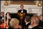 President George W. Bush welcomes guests in the State Dining Room of the White House, Thursday, Nov. 10, 2005, at the dinner celebrating the 40th Anniversary of the National Endowment for the Arts and the National Endowment for the Humanities. White House photo by Paul Morse