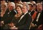 President George W. Bush and Mrs. Laura Bush listen to the evening's entertainment at the White House, Thursday, Nov. 10, 2005, following the dinner celebrating the 40th Anniversary of the National Endowment for the Arts and the National Endowment for the Humanities. White House photo by Paul Morse