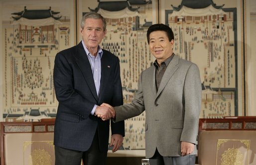 President George W. Bush and Korea President Moo Hyun Roh exchange handshakes Thursday, Nov. 17, 2005, after their meeting at the Hotel Hyundai in Gyeongju, Korea. White House photo by Eric Draper