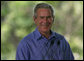 President George W. Bush smiles as he listens through an earpiece to a translation of the remarks by Brazil President Luiz Inacio Lula da Silva Saturday, Nov. 6, 2005, in Brasilia, Brazil. White House photo by Paul Morse