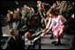 President George W. Bush reaches out to two girls after speaking Monday, Nov. 14, 2005, on the War on Terror at Elmendorf Air Force Base in Anchorage, Alaska. White House photo by Paul Morse