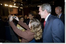 President George W. Bush poses for a photo with an audience member after delivering remarks in Brasilia, Brazil, Sunday, Nov. 6, 2005. White House photo by Eric Draper