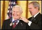 President George W. Bush presents the Presidential Medal of Freedom to actor Andy Griffith, one of 14 recipients of the 2005 Presidential Medal of Freedom, awarded Wednesday, Nov. 9, 2005 in the East Room. White House photo by Paul Morse