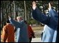 President George W. Bush waves to the crowd after joining his fellow APEC leaders for an official photograph Saturday, Nov. 19, 2005, at the Nurimaru APEC House in Busan, Korea. White House photo by Paul Morse