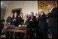 President George W. Bush acknowledges the applause of legislators and administration officials Tuesday, Aug. 2. 2005 in the East room of the White House, as he signs the CAFTA Implementation Act. White House photo by Paul Morse